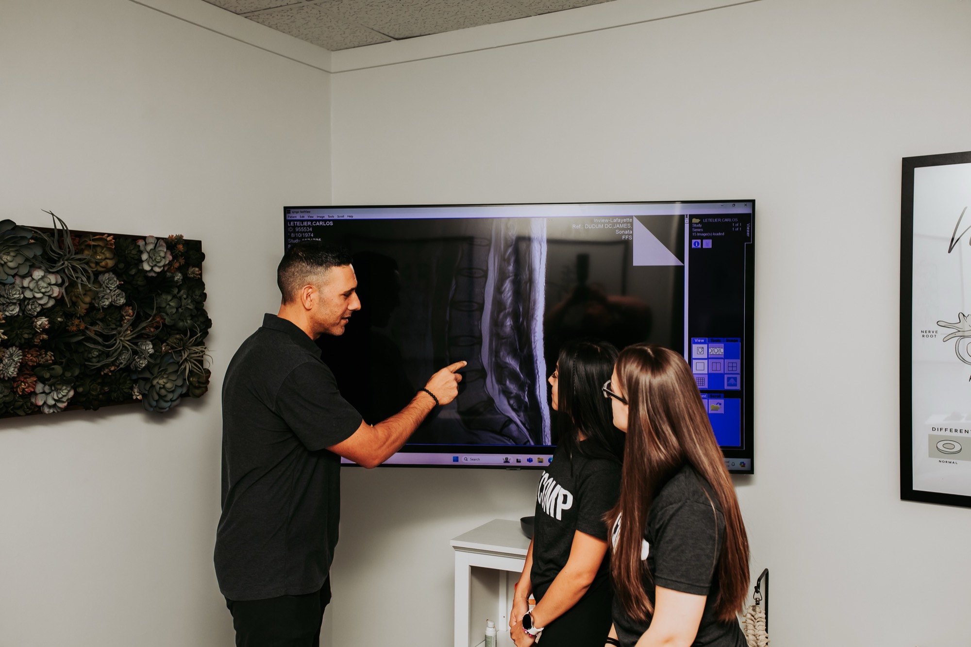 Dr. JD Dudum showing a patient their MRI at Dudum Decompression in Walnut Creek
